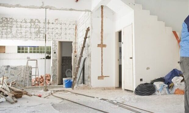 House renovation concept. Asian construction worker with hardhat working.